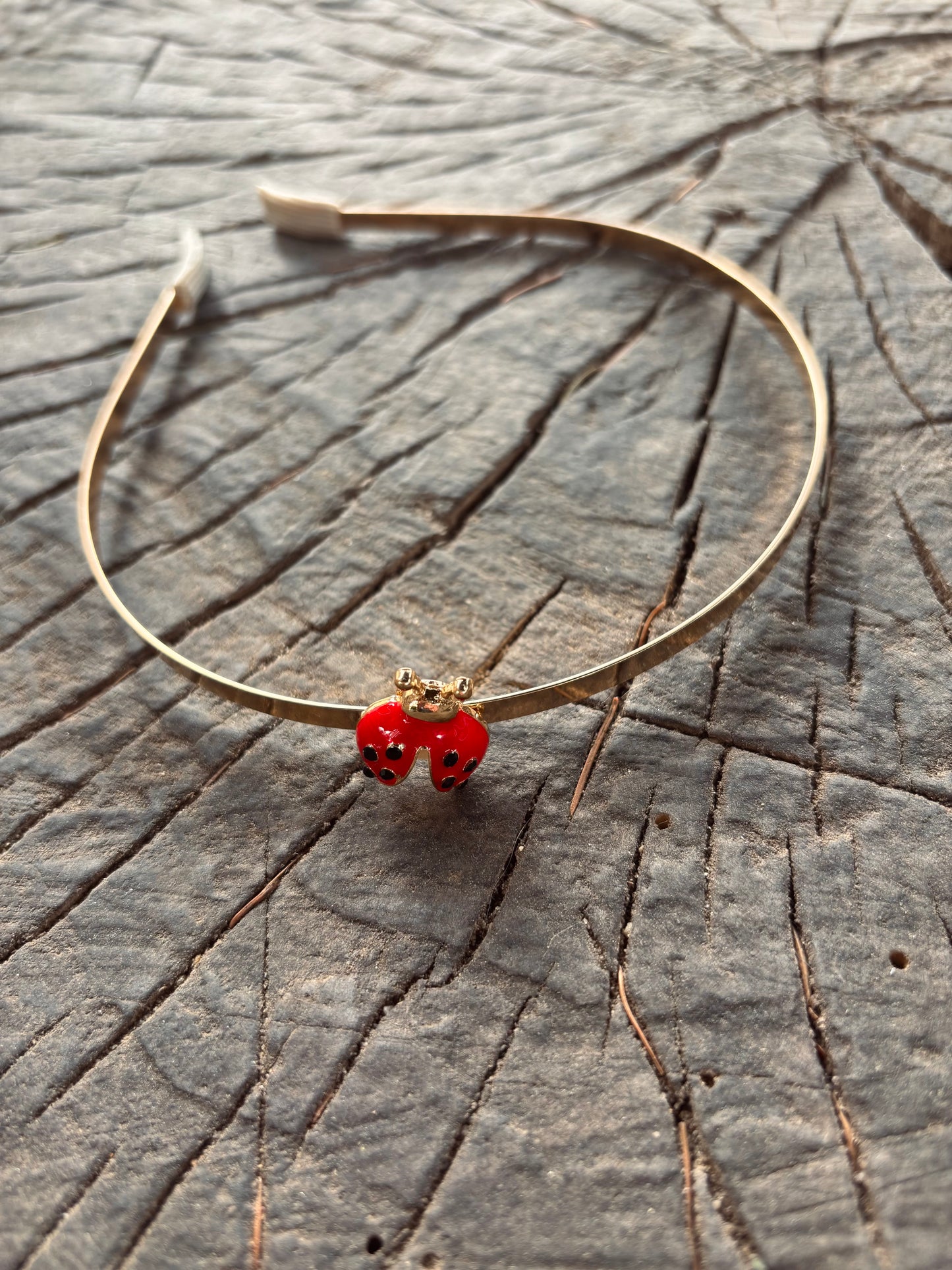 Gold headband with ladybug decoration